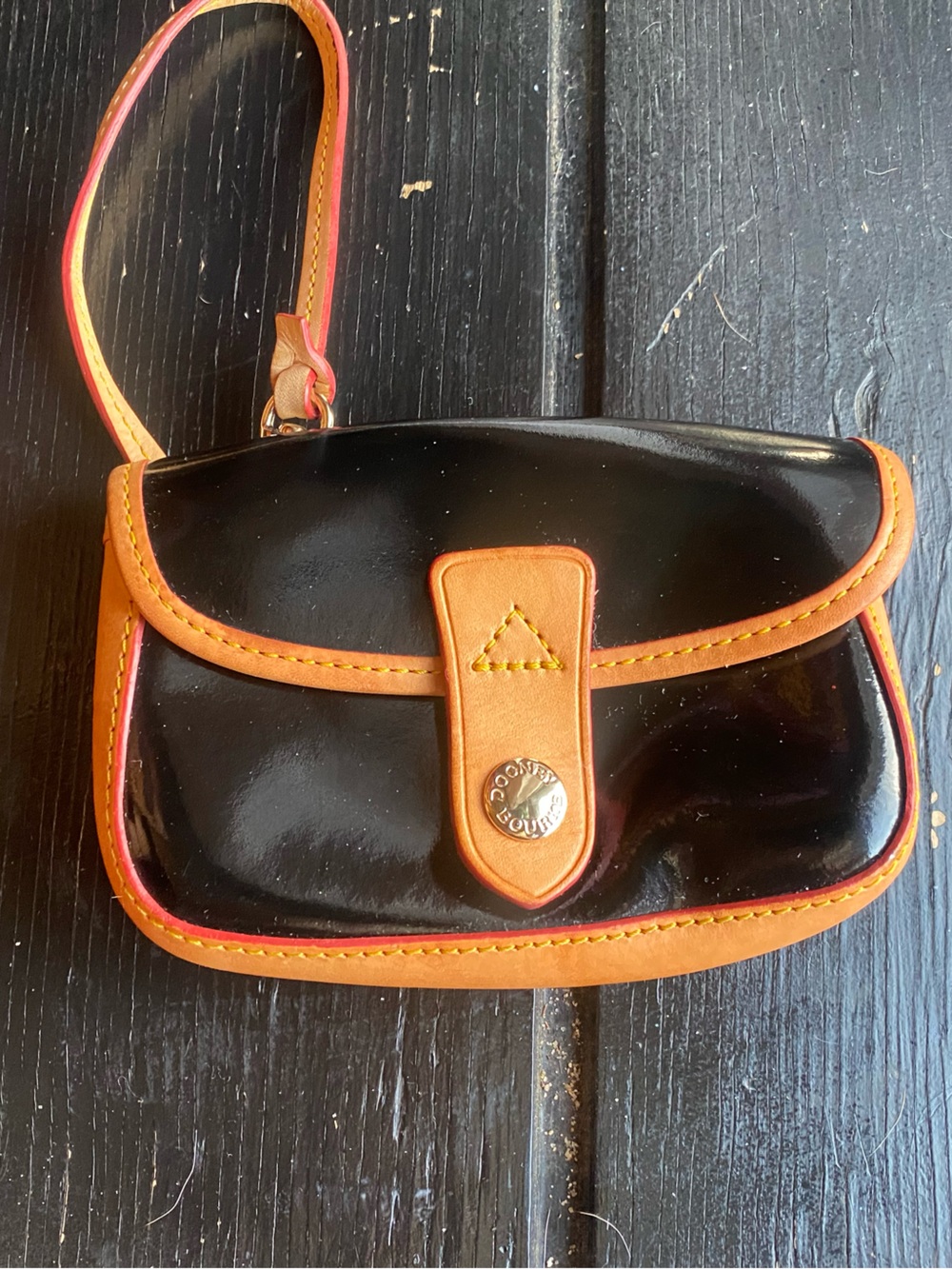Dooney & Bourke Black Patent Wristlet with Tan and Orange Trim